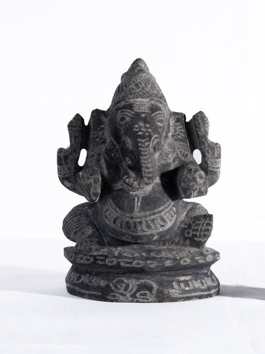 Black stone Vinayagar idol white background view handcrafted Ganesha statue for home decor vastu and spiritual placement.