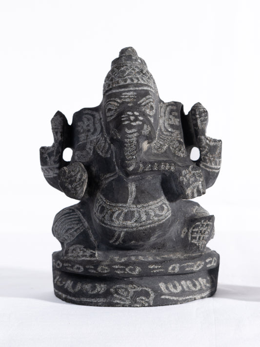 Black stone Vinayagar idol white background view handcrafted Ganesha statue for home decor vastu and spiritual placement.