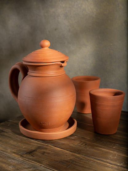 Handmade clay water Jug in traditional matka style by Village Decor, placed on a rustic wooden table.
