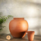 Handmade clay water Pot in traditional matka style by Village Decor, placed on a rustic wooden table.
