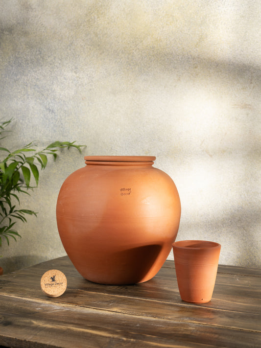Handmade clay water Pot in traditional matka style by Village Decor, placed on a rustic wooden table.
