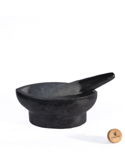 Polished stone Kharal with handle on white background.