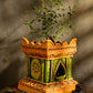 Handcrafted terracotta Tulsi Pot with Tulsi plant in traditional Vrindavan style, placed in a pooja setup with natural lighting and sacred decor.
