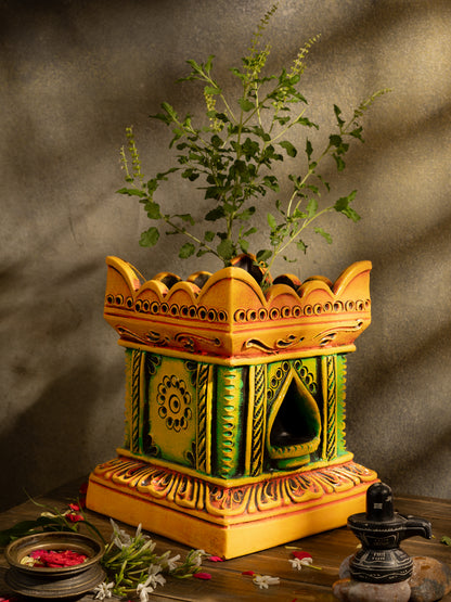 Handcrafted terracotta Tulsi Pot with Tulsi plant in traditional Vrindavan style, placed in a pooja setup with natural lighting and sacred decor.
