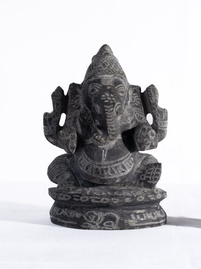 Black stone Vinayagar idol white background view handcrafted Ganesha statue for home decor vastu and spiritual placement.
