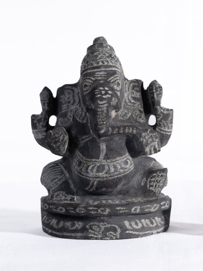 Black stone Vinayagar idol white background view handcrafted Ganesha statue for home decor vastu and spiritual placement.
